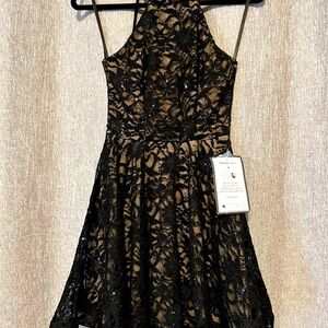 Black lace dress with tan underlay. Size 7/8,fits like a 3/4.